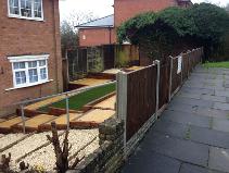 Transformation in Kings Norton, artificial turf, sleepers, slabs and stones.