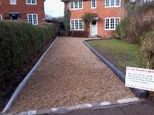 Gold gravel driveway with bullnose kerbing and tumble block border.