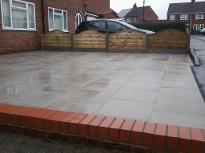 Slabbed driveway with decorative fencing in Wythal.