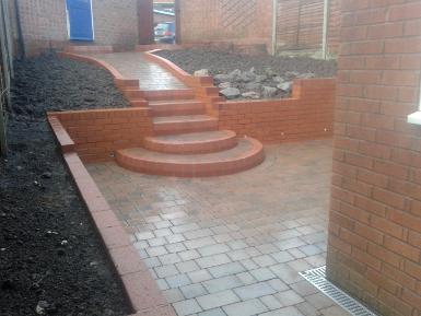 Walls, bullnose shaped step and block paved patio with aco drains in Selly Oak.