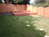Domed featheredge fencing and double decked decking.