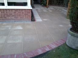 Garden transformed with new 18 inch slabs and red blocks.