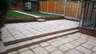 Split level random paving kits with sleepers and new lawns.